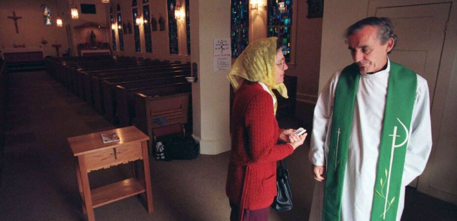 Priest talks to parishioner