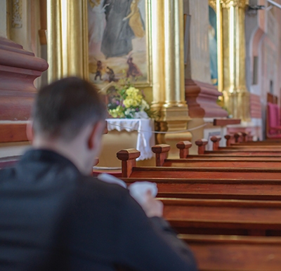 man praying in church